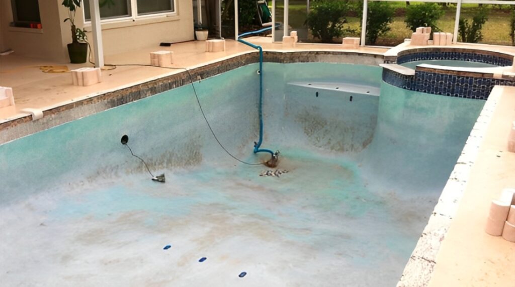 Signs your pool needs resurfacing: cracked and stained pool surface
